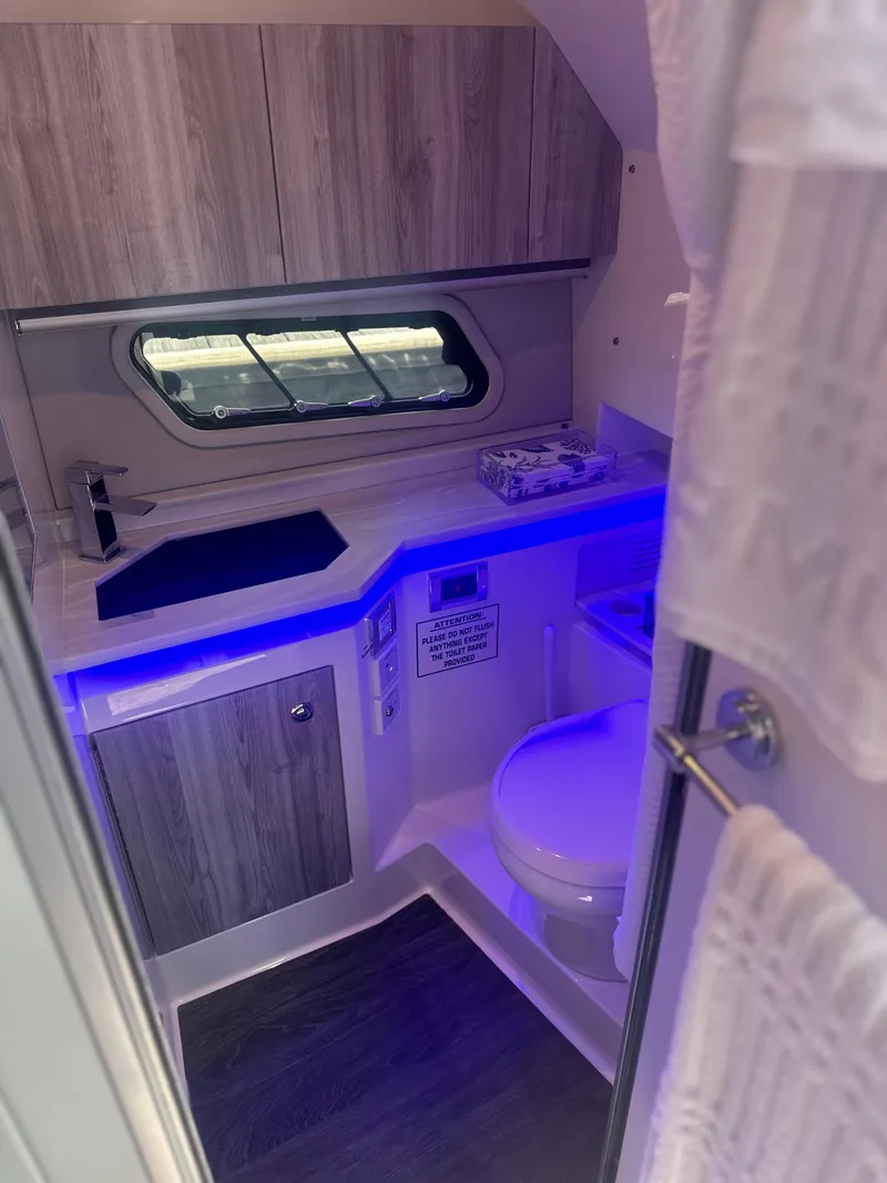 Slide: The Image of 2022 Formula 380 Super Sport Crossover OB bathroom with modern design and blue LED lighting. - 10