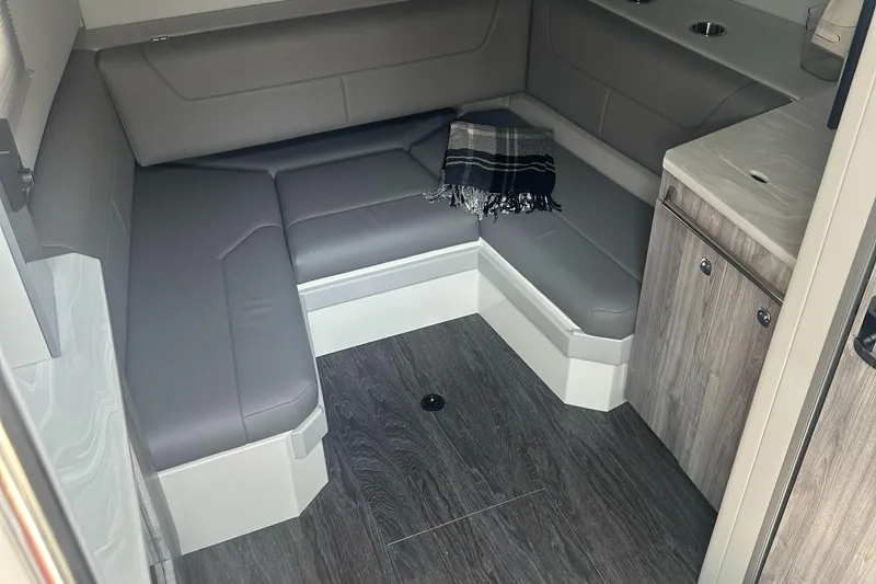 Slide: The Image of 2022 Formula 380 Super Sport Crossover OB interior with gray seating and wood accents. - 12