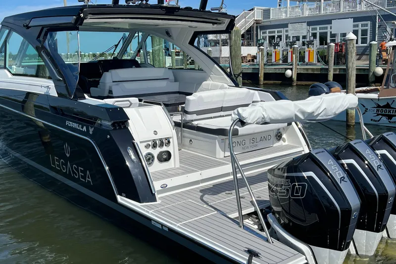 Slide: The Image of 2022 Formula 380 Super Sport Crossover OB docked, featuring sleek design and powerful outboard engines. - 4