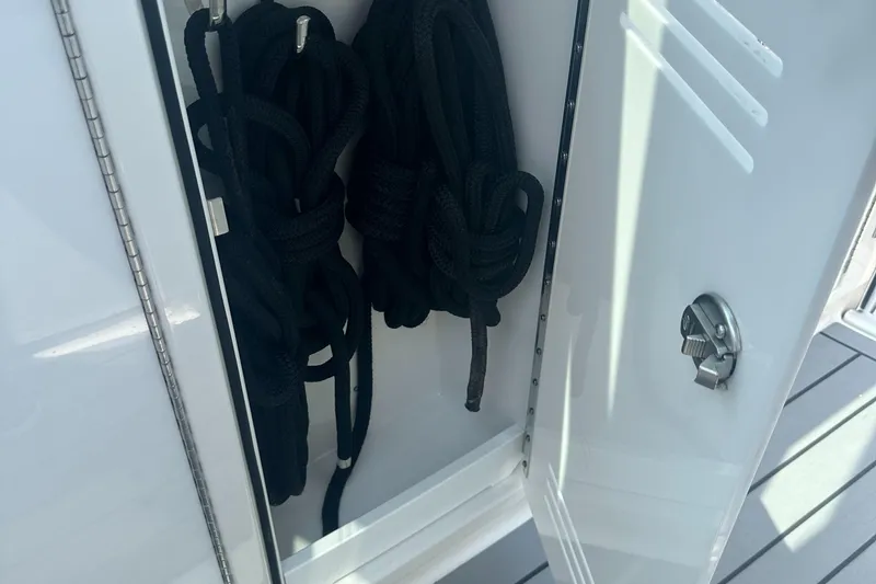 Slide: The Image of Storage compartment with black ropes on a 2022 Formula 380 Super Sport Crossover OB. - 8