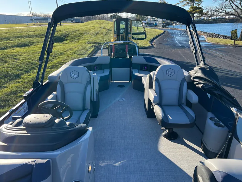Slide: The Image of 2025 South Bay 224 RS Performance Package boat interior with seating and steering wheel. - 11