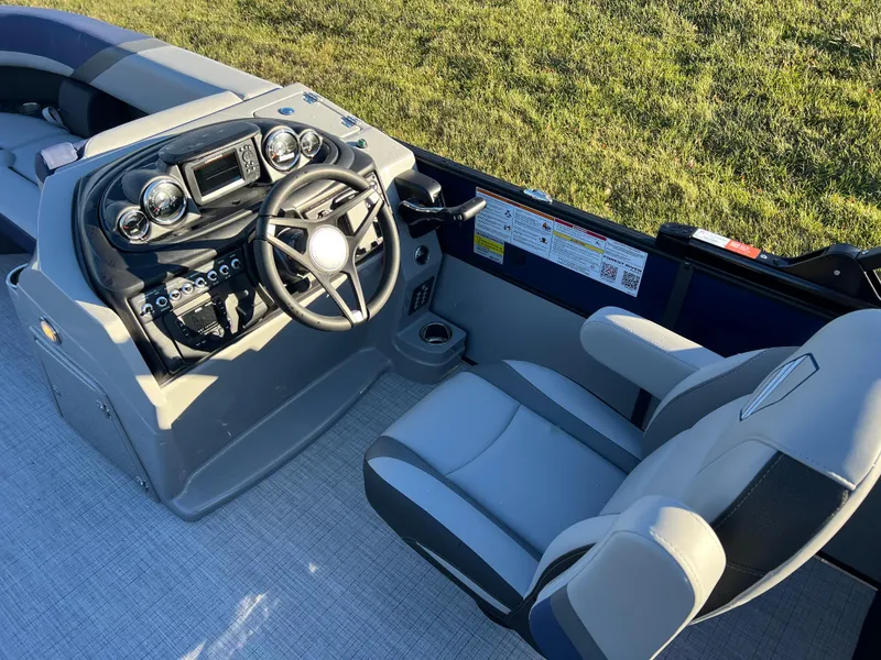 Slide: The Image of 2025 South Bay 224 RS Performance Package boat interior with steering console and seating. - 17