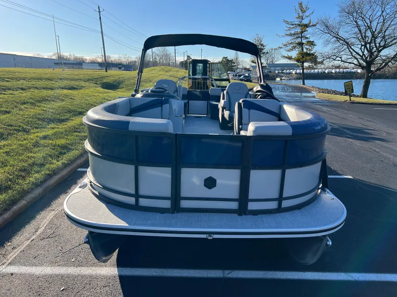Slide: The Image of 2025 South Bay 224 RS Performance pontoon boat parked near a lake. - 3