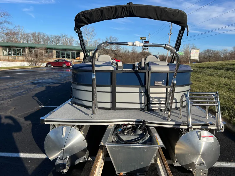 Slide: The Image of 2025 South Bay 224 RS Performance pontoon boat on trailer, parked outdoors. - 6