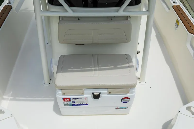 Slide: The Image of 2025 Boston Whaler 190 Montauk boat interior with cushioned seating and storage. - 13