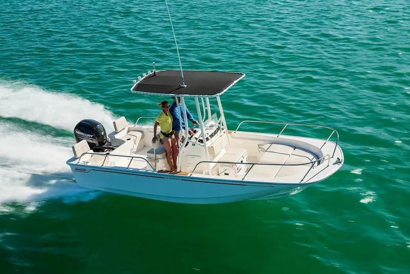 Slide: The Image of 2025 Boston Whaler 190 Montauk cruising on clear blue water. - 22