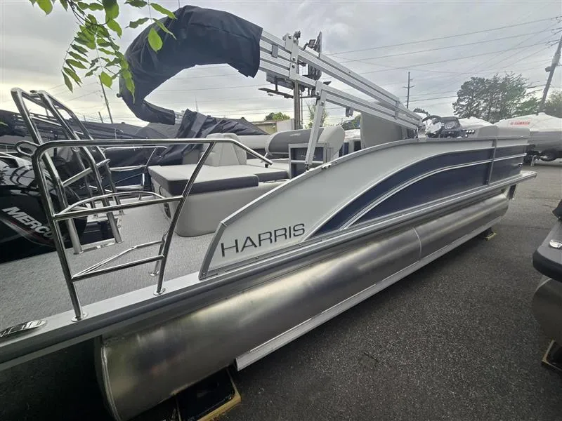 Slide: The Image of 2025 Harris Cruiser 230 pontoon boat with sleek design and modern features. - 2