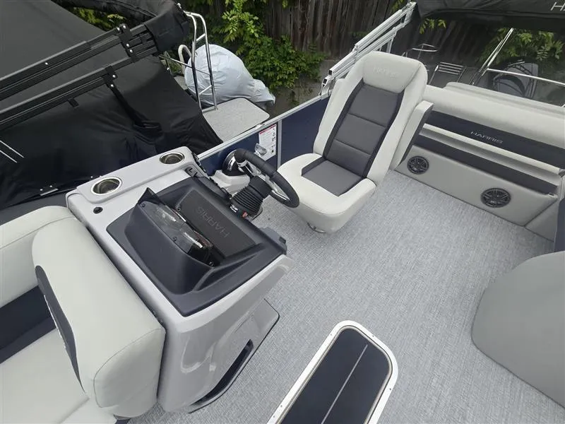Slide: The Image of 2025 Harris Cruiser 230 boat interior with modern seating and steering console. - 5