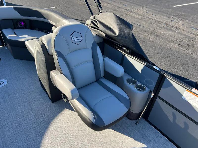 Slide: The Image of 2025 South Bay 222 RS boat interior with gray captain's chair and cup holders. - 12