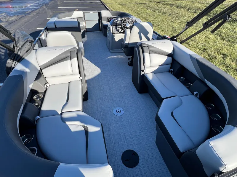 Slide: The Image of 2025 South Bay 222 RS pontoon boat interior with gray seating and steering console. - 16