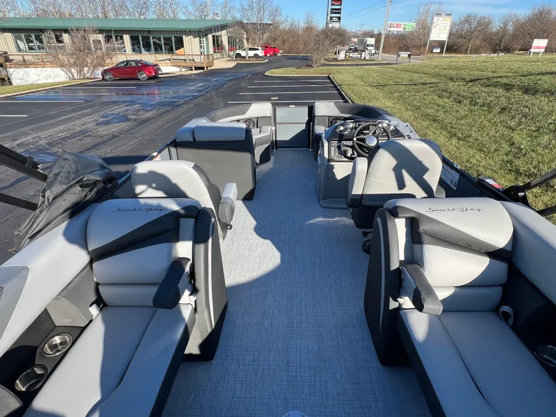 Slide: The Image of 2025 South Bay 222 RS pontoon boat interior with modern seating and steering console. - 17