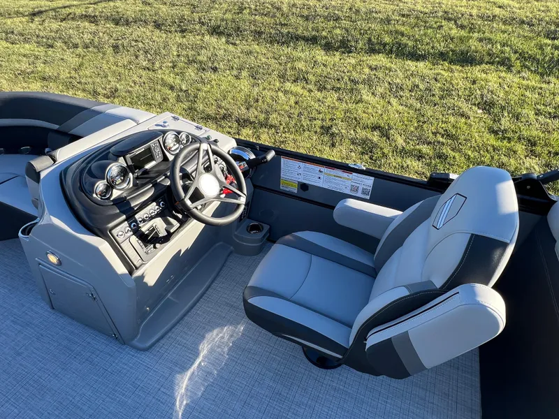 Slide: The Image of 2025 South Bay 222 RS boat interior with steering console and captain's chair. - 19