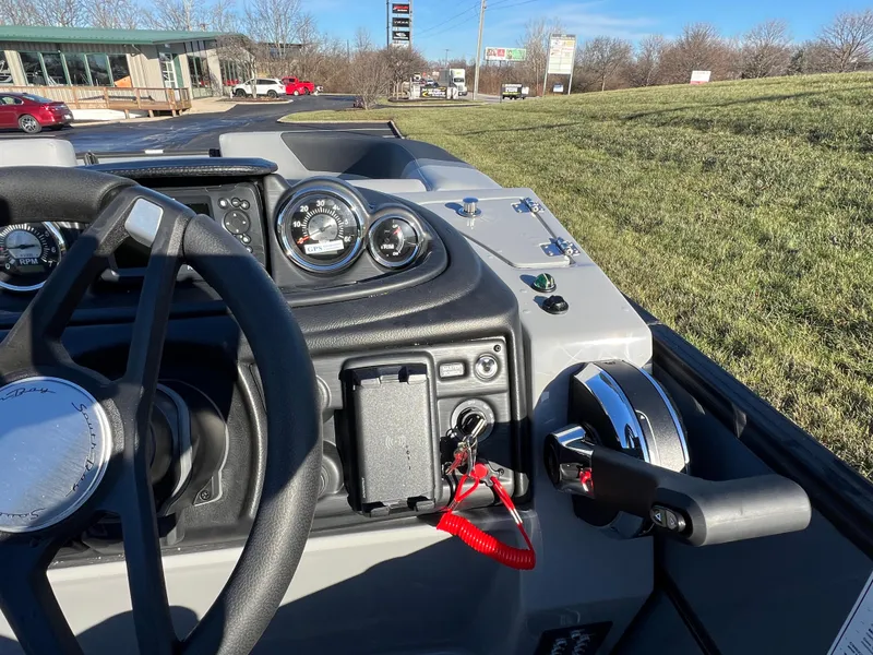 Slide: The Image of 2025 South Bay 222 RS boat dashboard with steering wheel and controls. - 21