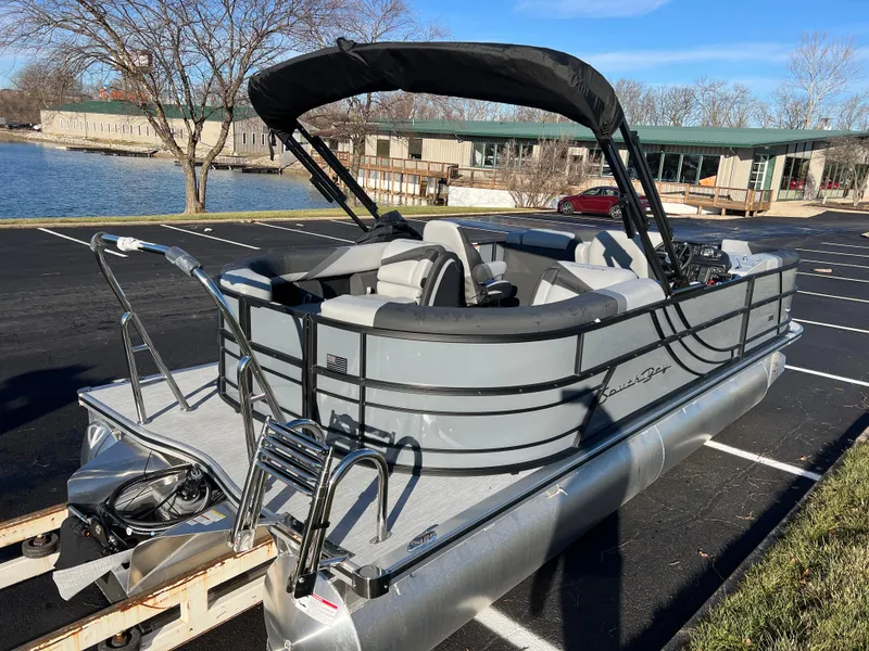 Slide: The Image of 2025 South Bay 222 RS pontoon boat parked near a lake on a sunny day. - 5