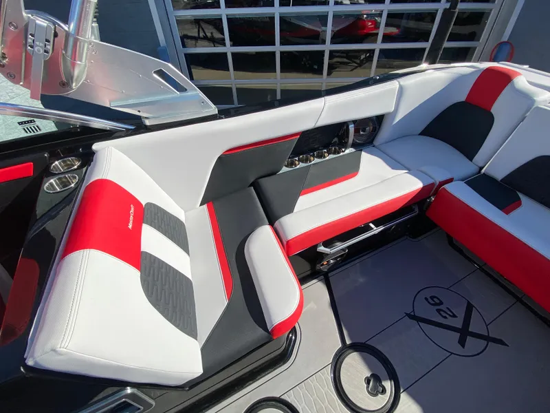 Slide: The Image of 2021 MasterCraft X26 boat interior with red, black, and white seating. - 13