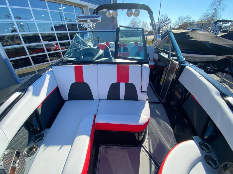 Slide: The Image of 2021 MasterCraft X26 boat interior with red and white seating, modern design. - 19