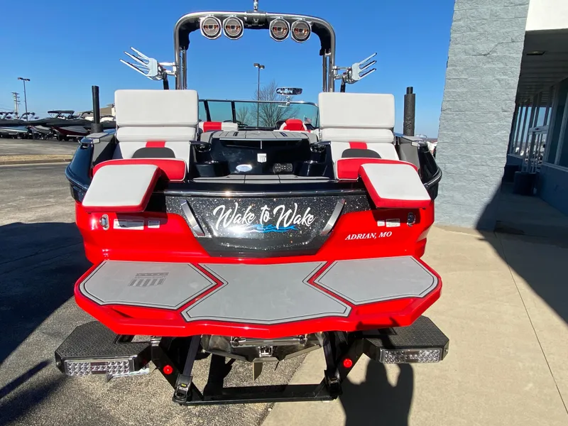 Slide: The Image of 2021 MasterCraft X26 boat, red and gray, rear view, "Wake to Wake" decal. - 2