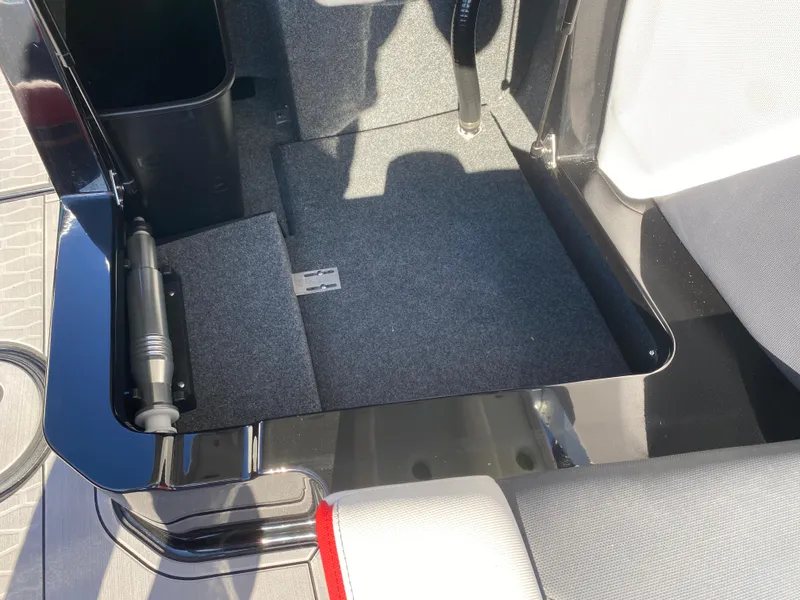 Slide: The Image of 2021 MasterCraft X26 boat interior storage compartment with carpeted flooring. - 20