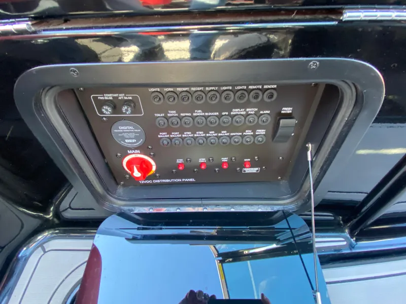 Slide: The Image of Control panel of 2021 MasterCraft X26 boat with various switches and indicators. - 22
