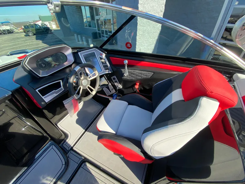 Slide: The Image of 2021 MasterCraft X26 boat interior with modern dashboard and red-accented captain's seat. - 24