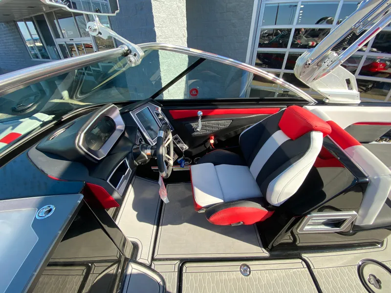 Slide: The Image of 2021 MasterCraft X26 boat interior with modern dashboard and red-black seating. - 25