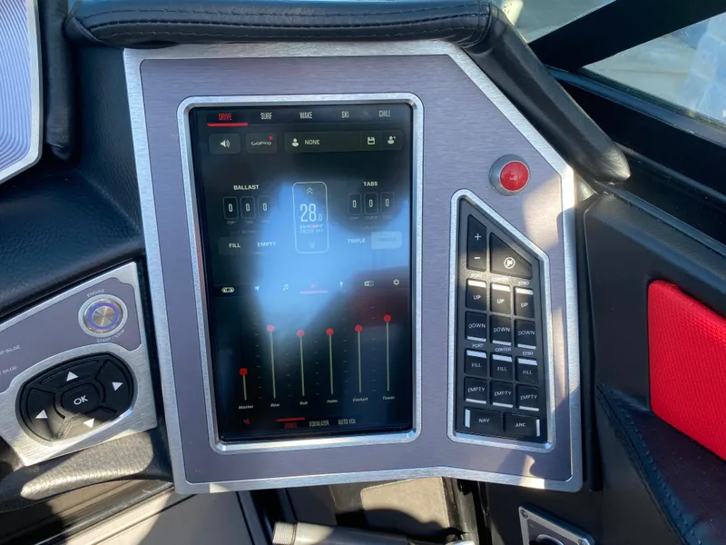 Slide: The Image of 2021 MasterCraft X26 boat dashboard with touchscreen controls and navigation system. - 26