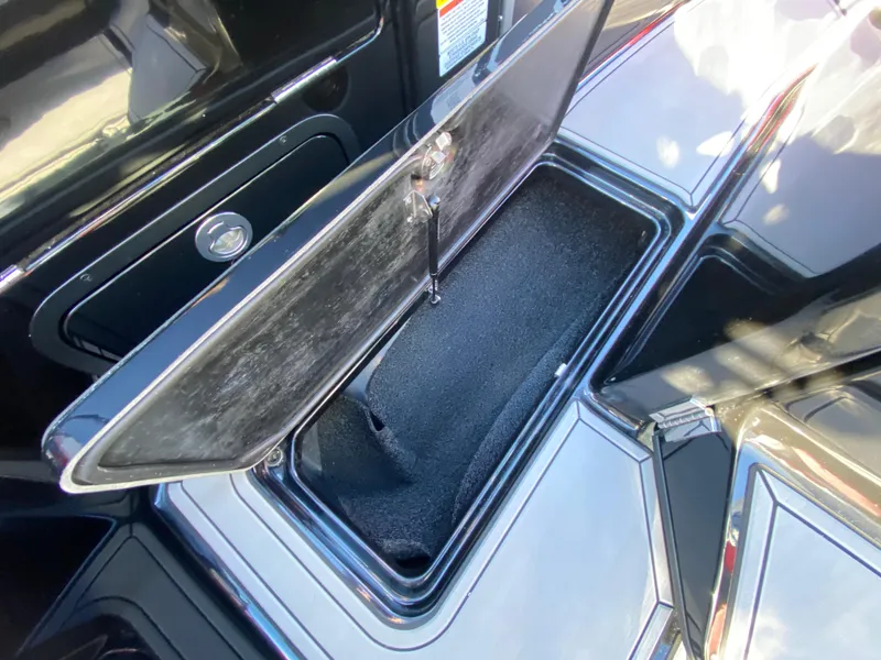 Slide: The Image of 2021 MasterCraft X26 boat storage compartment open, showcasing interior space. - 31