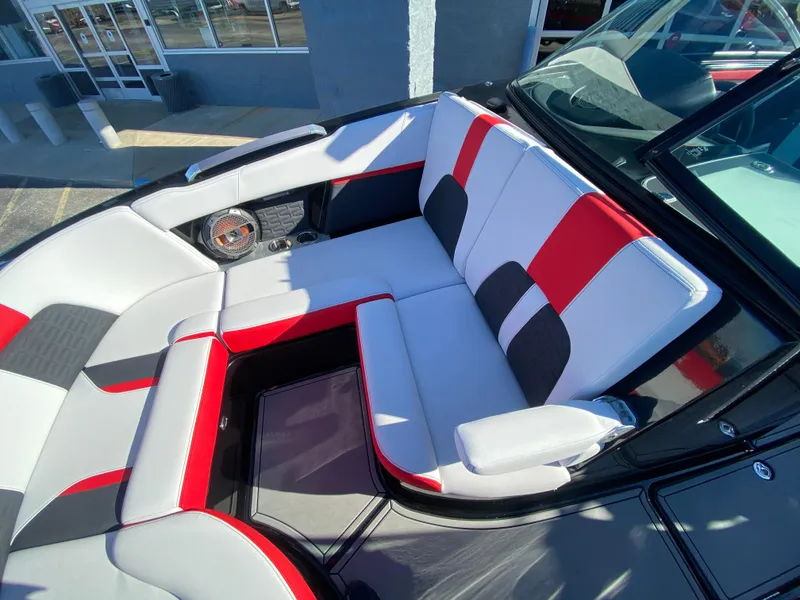 Slide: The Image of 2021 MasterCraft X26 boat interior with red, black, and white seating. - 34