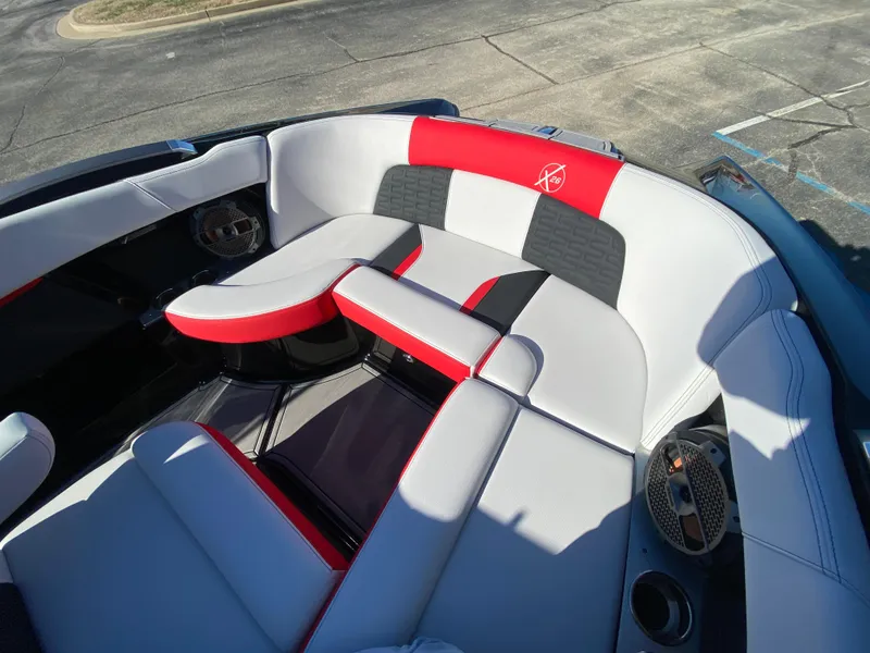 Slide: The Image of 2021 MasterCraft X26 boat interior with red and gray seating. - 35