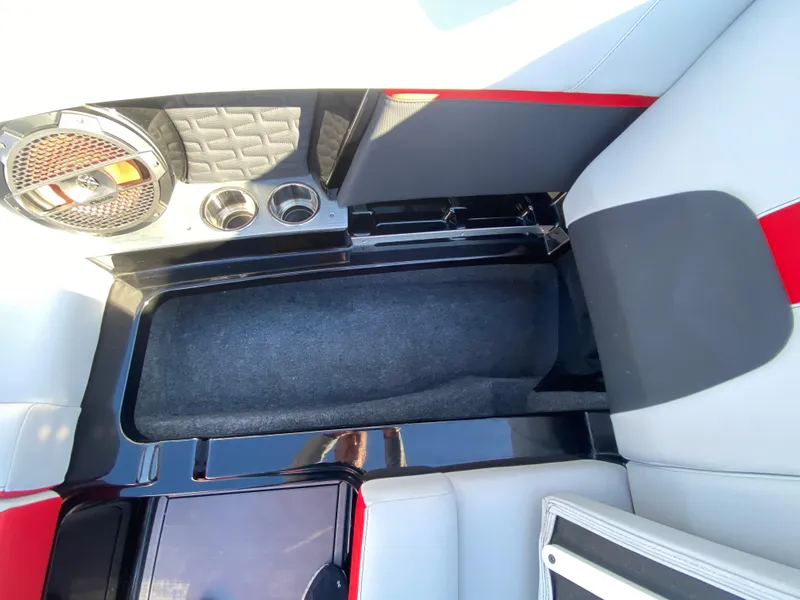 Slide: The Image of 2021 MasterCraft X26 interior with speaker, cup holders, and seating area. - 36