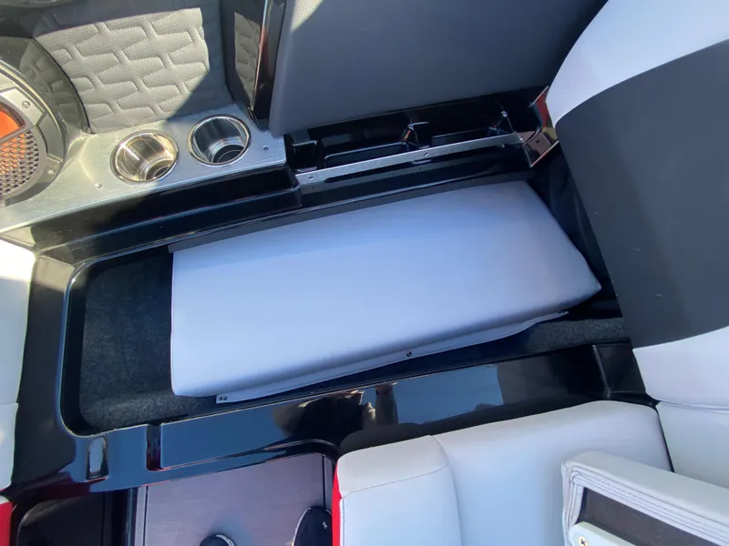 Slide: The Image of 2021 MasterCraft X26 interior storage compartment with cup holders and seating. - 37