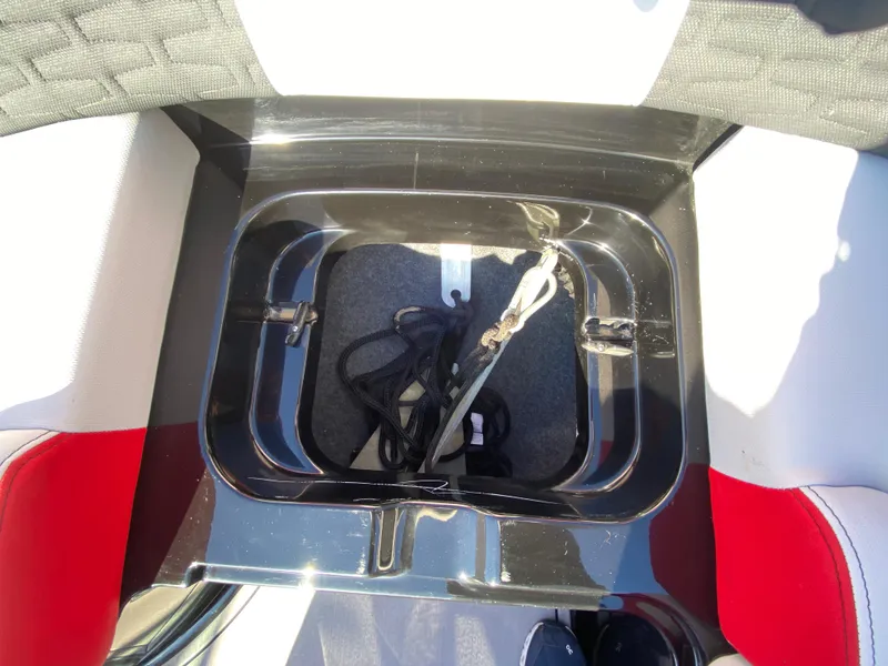 Slide: The Image of MasterCraft X26 2021 boat storage compartment with ropes inside. - 38