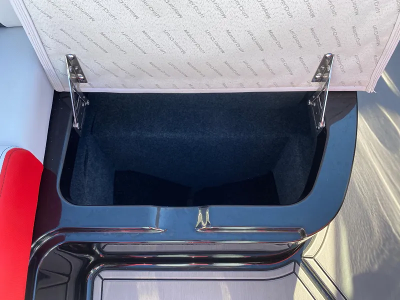 Slide: The Image of Open storage compartment in 2021 MasterCraft X26 boat interior. - 40