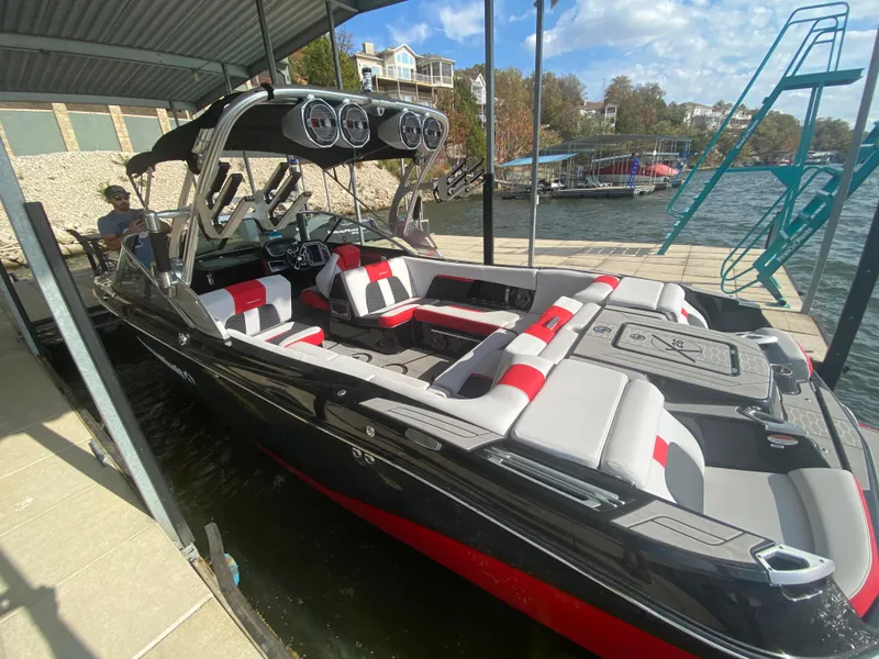 Slide: The Image of 2021 MasterCraft X26 boat docked, featuring sleek design and spacious seating. - 46