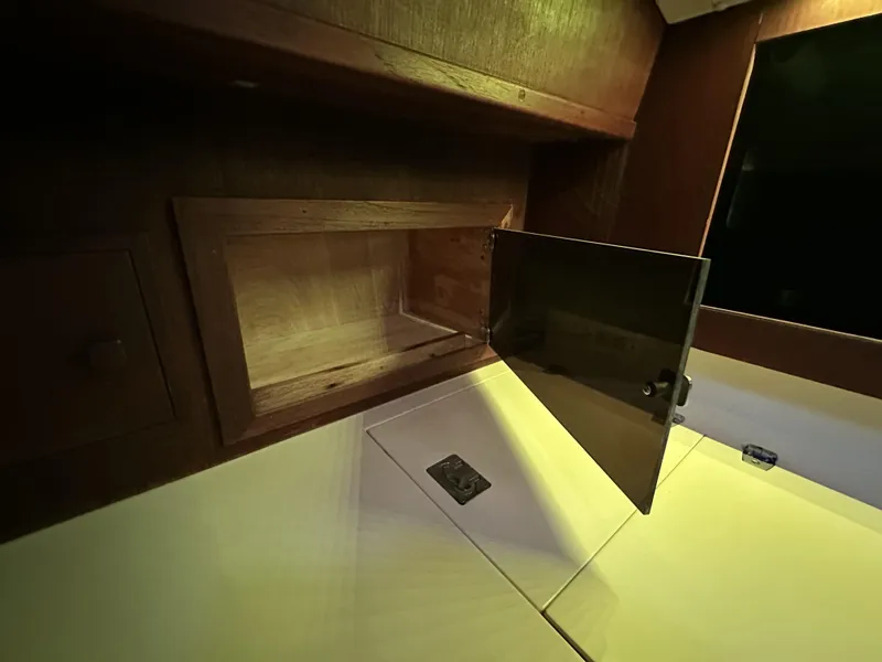 Slide: The Image of Interior of 1989 Canadian Sailcraft CS40 yacht with open wooden cabinet. - 10