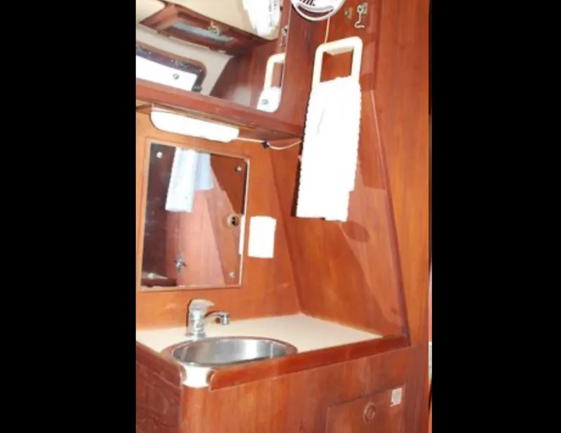 Slide: The Image of 1989 Canadian Sailcraft CS40 yacht bathroom with wooden cabinetry and stainless steel sink. - 14