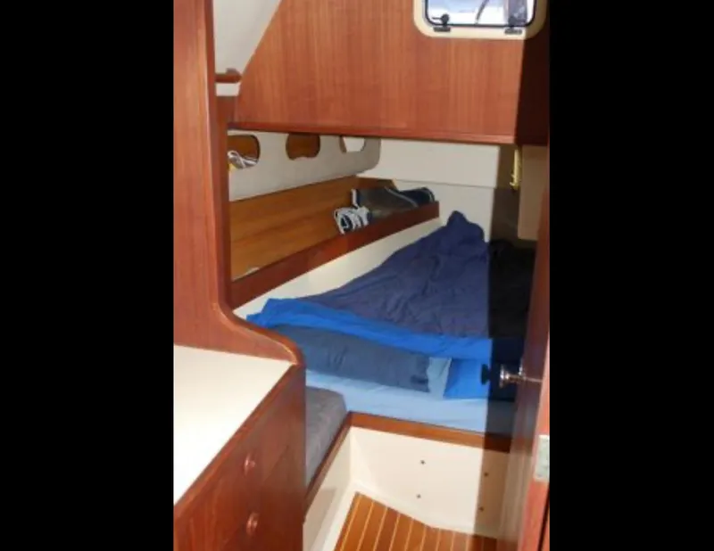 Slide: The Image of Interior cabin of 1989 Canadian Sailcraft CS40 sailboat with wooden furnishings and cozy bedding. - 17