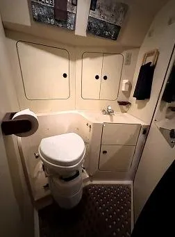 Slide: The Image of 1989 Canadian Sailcraft CS40 yacht bathroom with compact design and storage cabinets. - 18