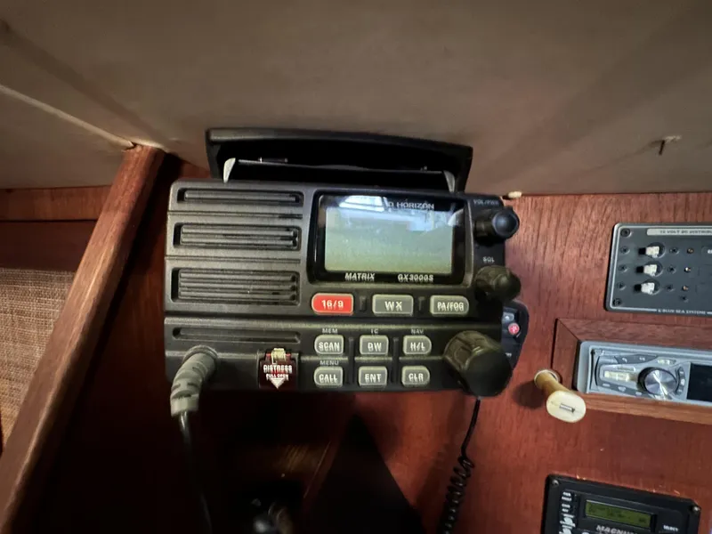 Slide: The Image of VHF radio equipment on 1989 Canadian Sailcraft CS40 yacht, featuring control panel and display. - 22