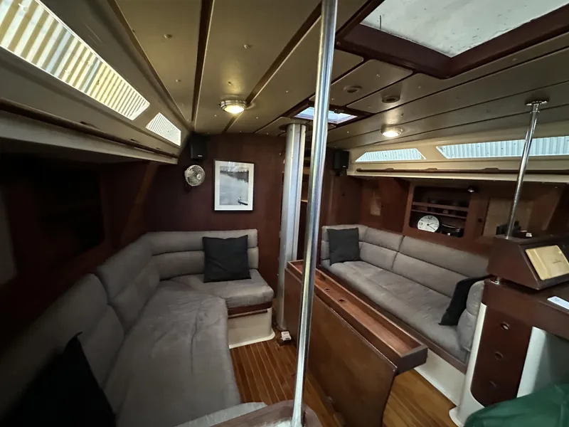 Slide: The Image of 1989 Canadian Sailcraft CS40 yacht interior with cozy seating and wooden finishes. - 3