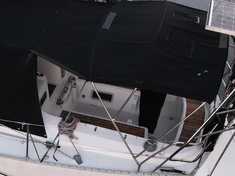 Slide: The Image of 1989 Canadian Sailcraft CS40 sailboat with black canopy and deck view. - 30