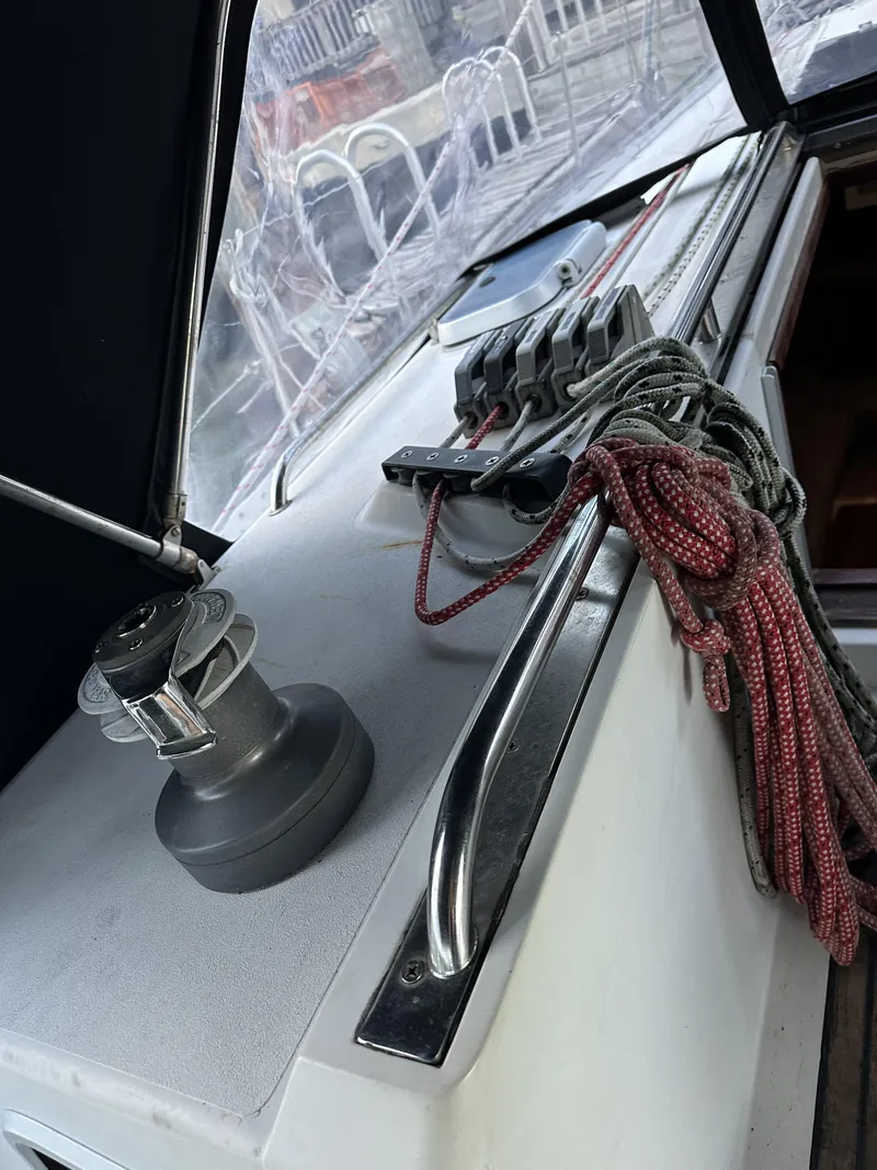 Slide: The Image of 1989 Canadian Sailcraft CS40 yacht deck with winch, ropes, and railing. - 32