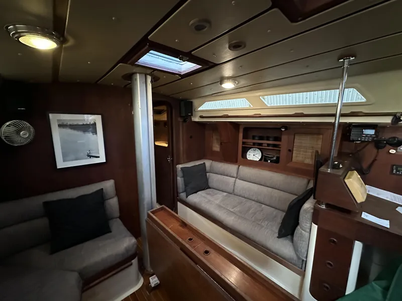 Slide: The Image of Interior of 1989 Canadian Sailcraft CS40 yacht, featuring cozy seating and elegant wood finishes. - 4