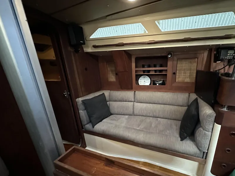 Slide: The Image of Interior of 1989 Canadian Sailcraft CS40 yacht with cozy seating and wooden cabinetry. - 6
