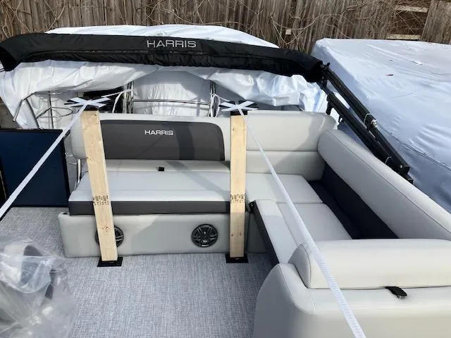 Slide: The Image of 2025 Harris Cruiser 210 pontoon boat interior with gray seating and protective cover. - 5