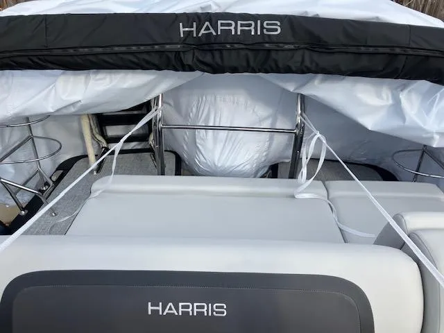 Slide: The Image of 2025 Harris Cruiser 210 boat interior with protective cover and seating. - 7