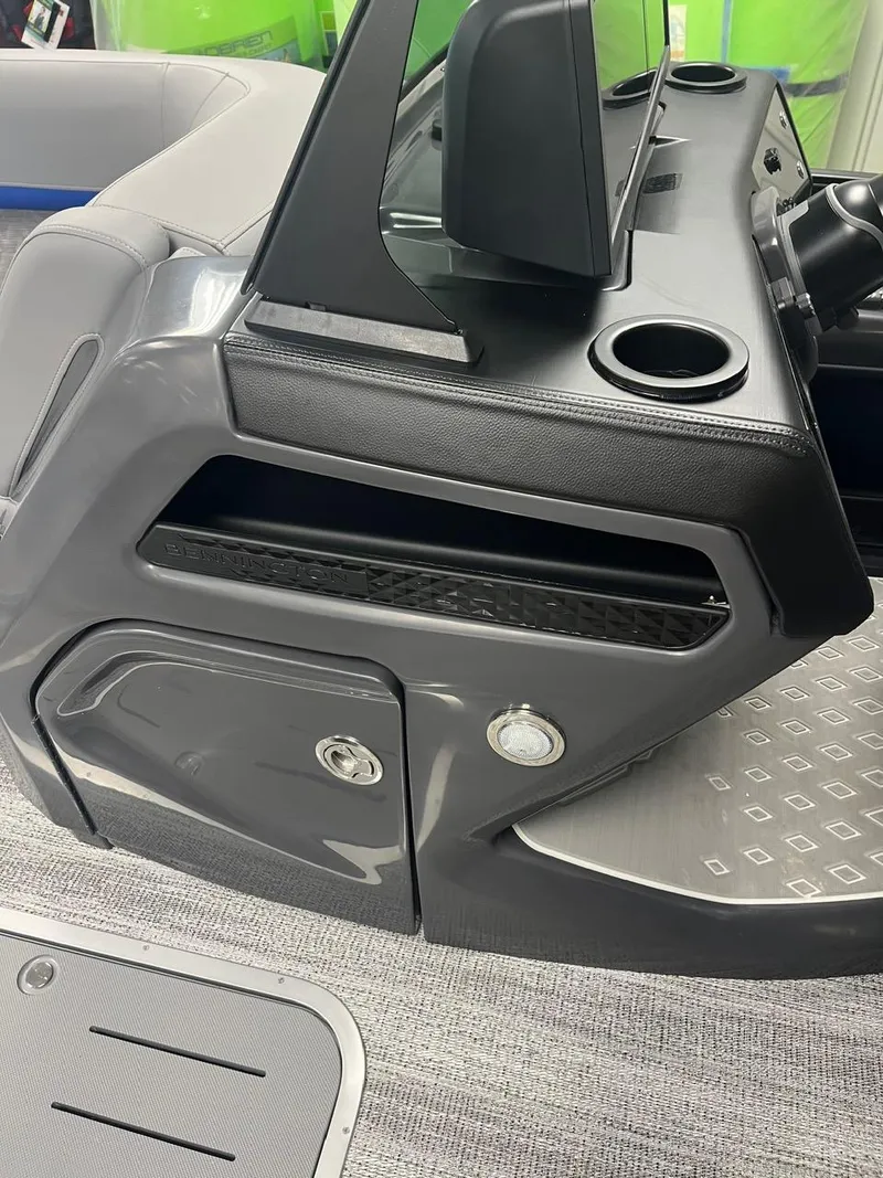 Slide: The Image of 2025 Bennington 24 MSB boat console with cup holders and storage compartments. - 11