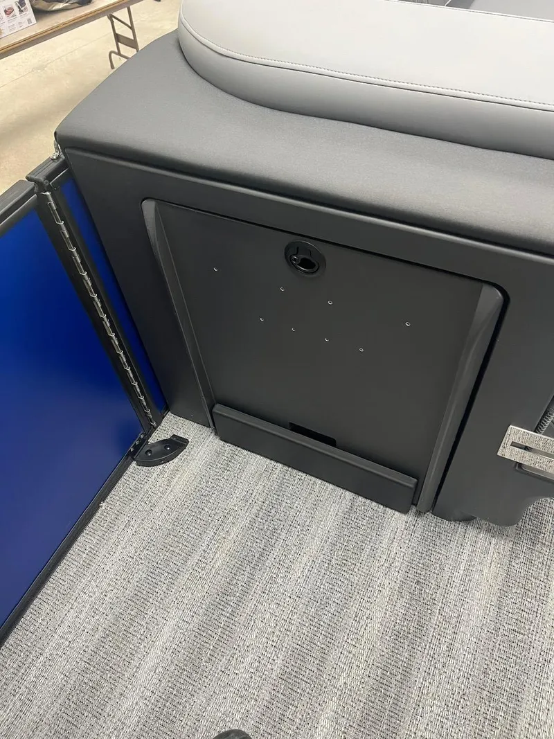 Slide: The Image of 2025 Bennington 24 MSB boat interior with storage compartment and cushioned seating. - 14