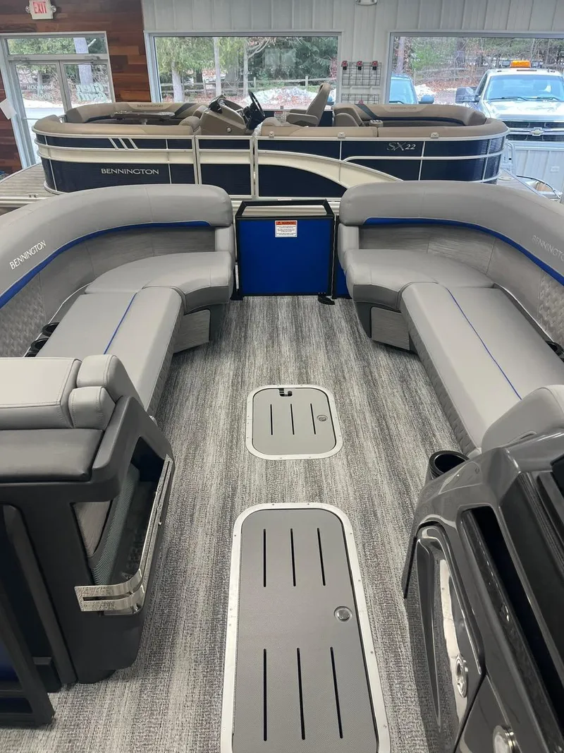Slide: The Image of 2025 Bennington 24 MSB pontoon boat interior with gray seating and modern design. - 16