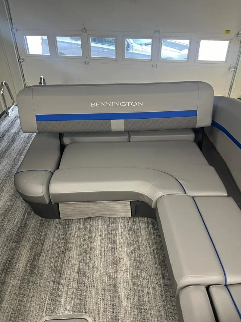 Slide: The Image of 2025 Bennington 24 MSB boat interior with gray seating and blue accents. - 5